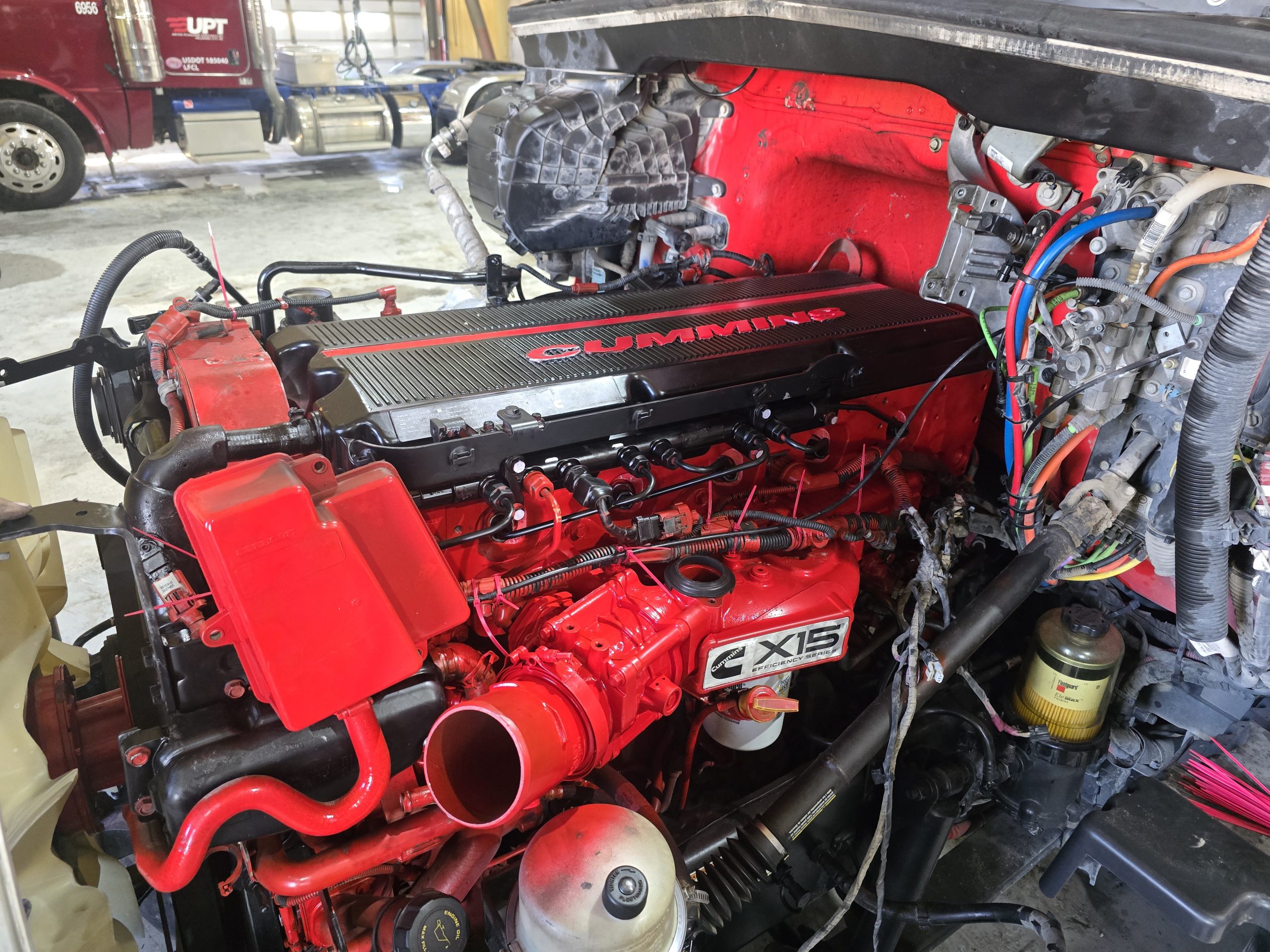 Red diesel engine exposed during repair in the Burnside shop